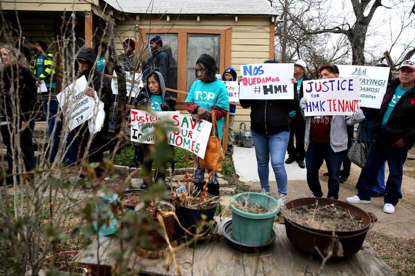 HMK tenants gather with signs during a press conference outside a HMK tenant's home in West...
