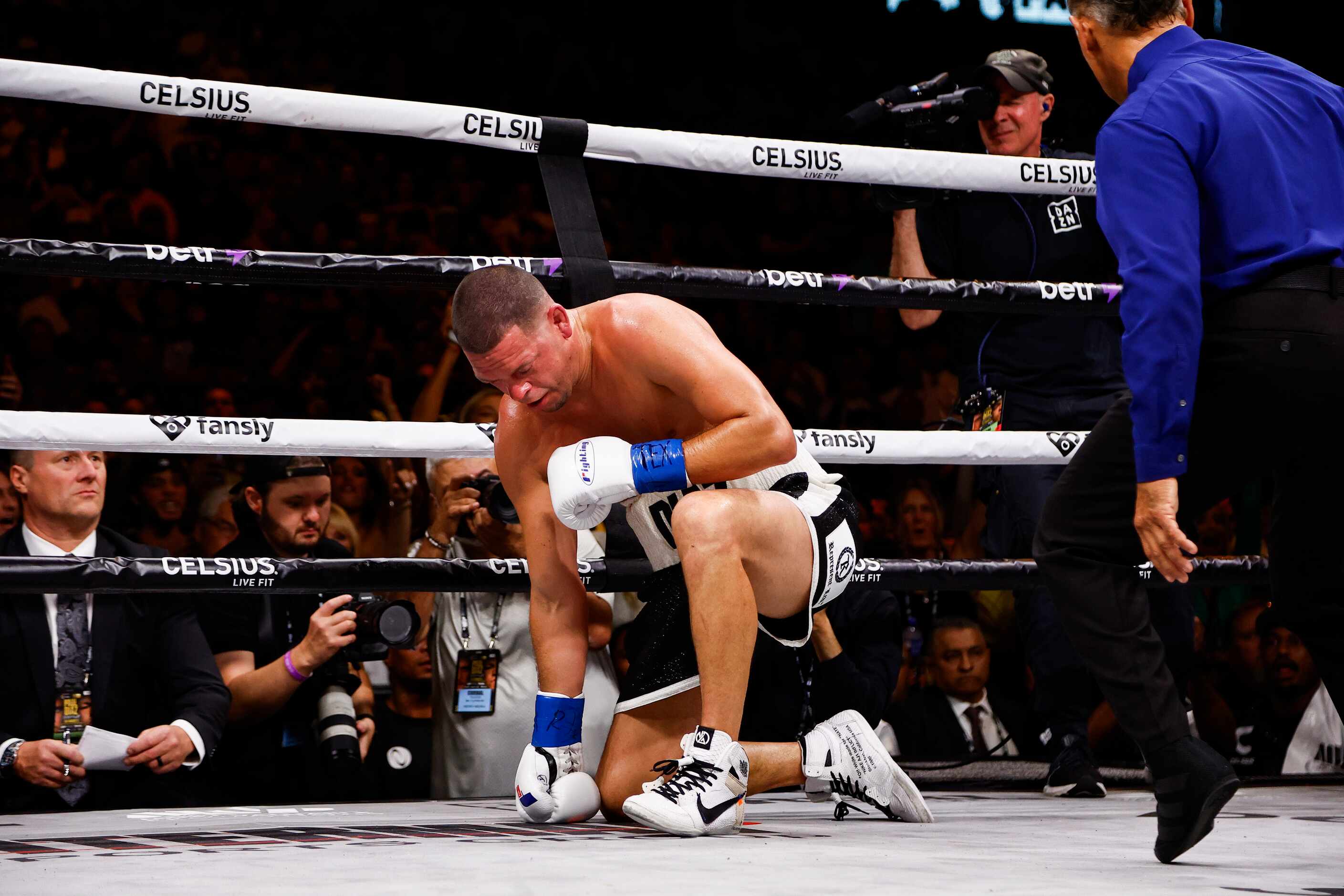 Nate Diaz goes down on one knee during a boxing match against Jake Paul, not pictured, in...