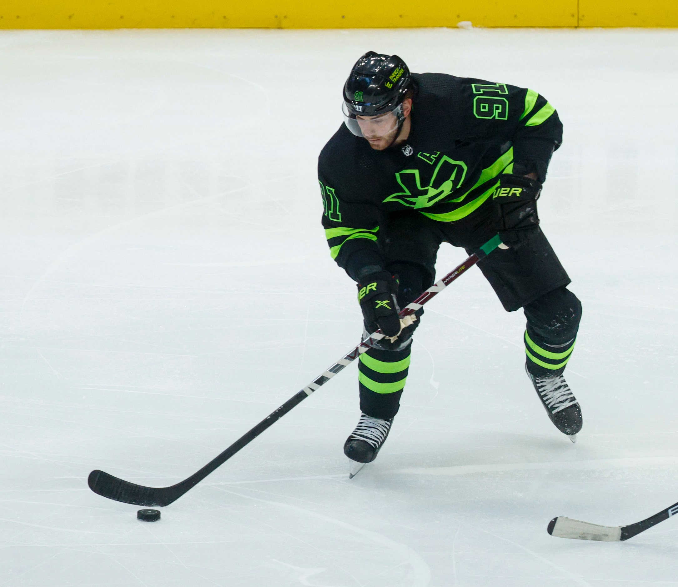 Dallas Stars center Tyler Seguin (91) handles the puck during the second period of an NHL...