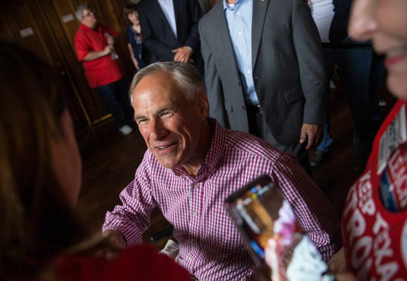 Texas Governor Greg Abbott greets supporters before speaking at a Collin County Republican...
