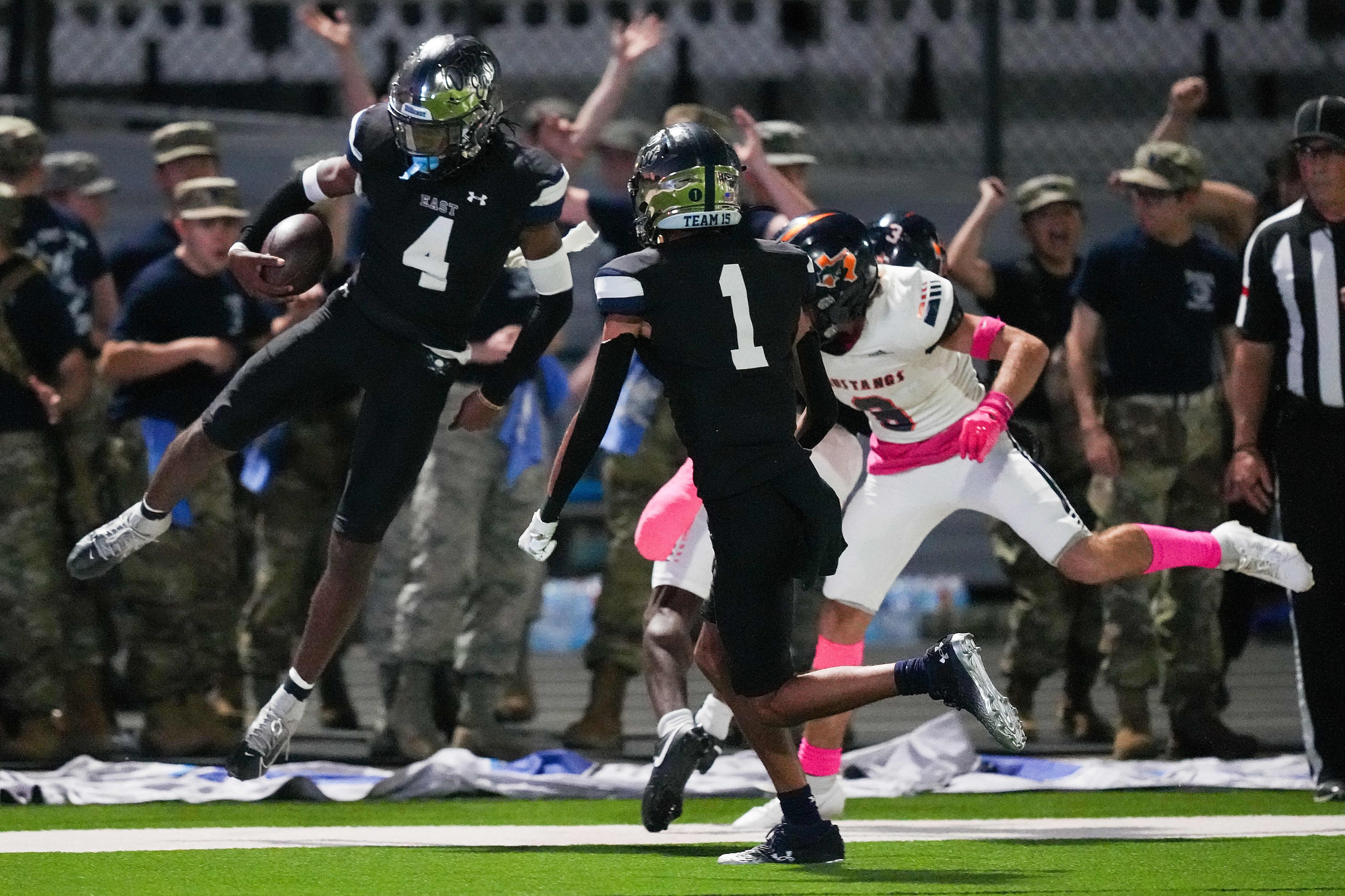 Wylie East quarterback Howard Fisher IV (4) scores on a touchdown run past Sachse linebacker...