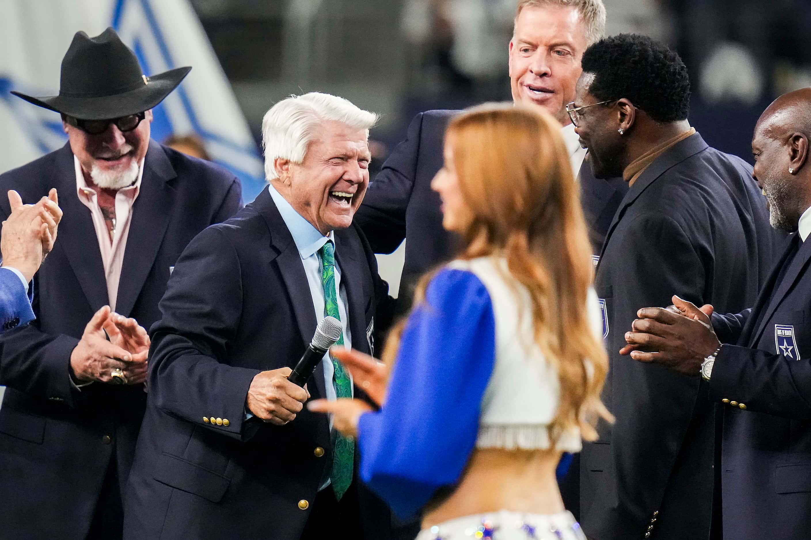 Former Dallas Cowboys head coach Jimmy Johnson celebrates with former players as he is...