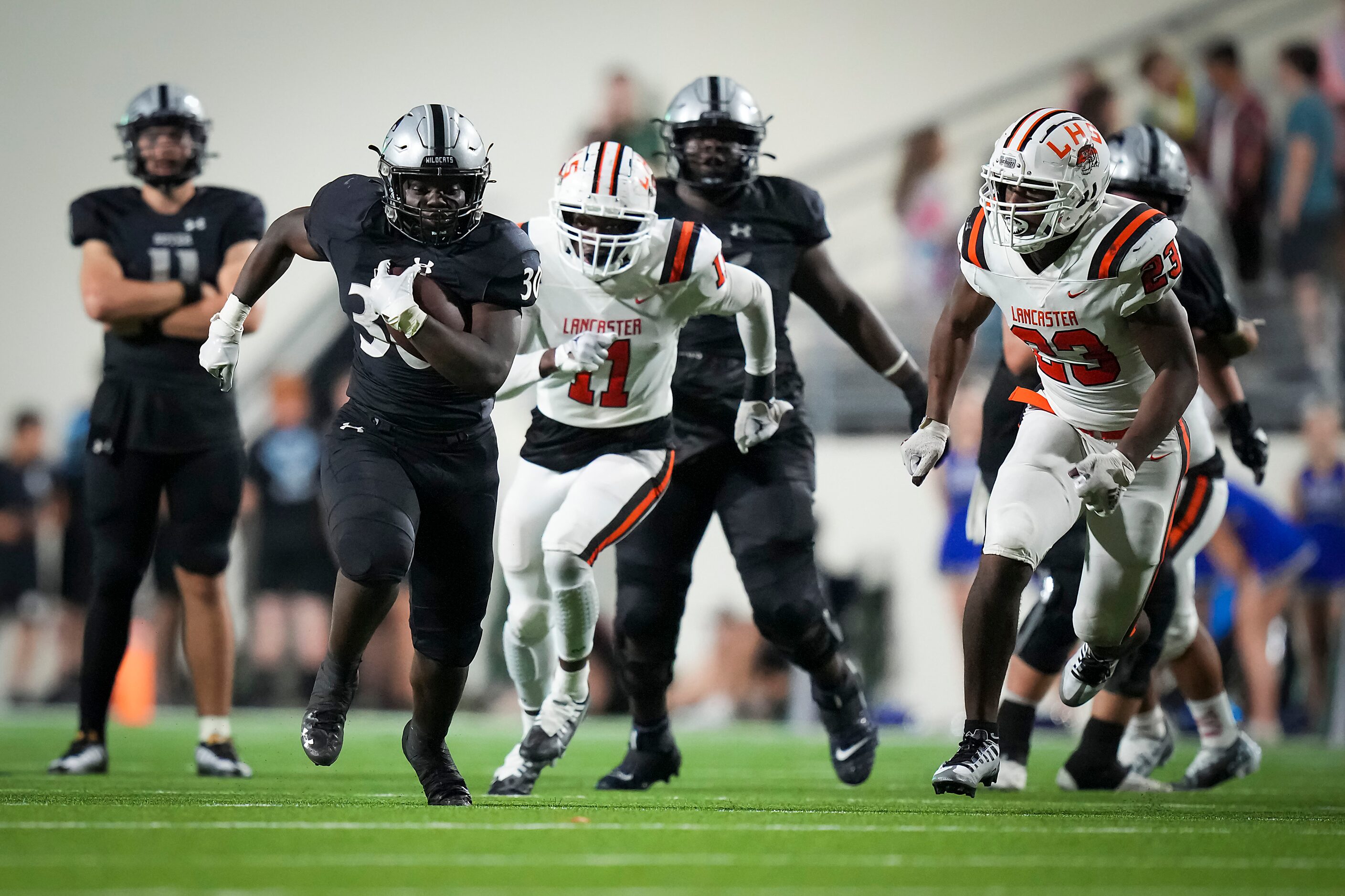 Denton Guyer running back Ahmed Yussuf (30) races past Lancaster defensive lineman Sa'Darion...