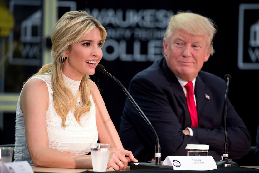 President Donald Trump listens as his daughter Ivanka Trump speaks at a workforce...