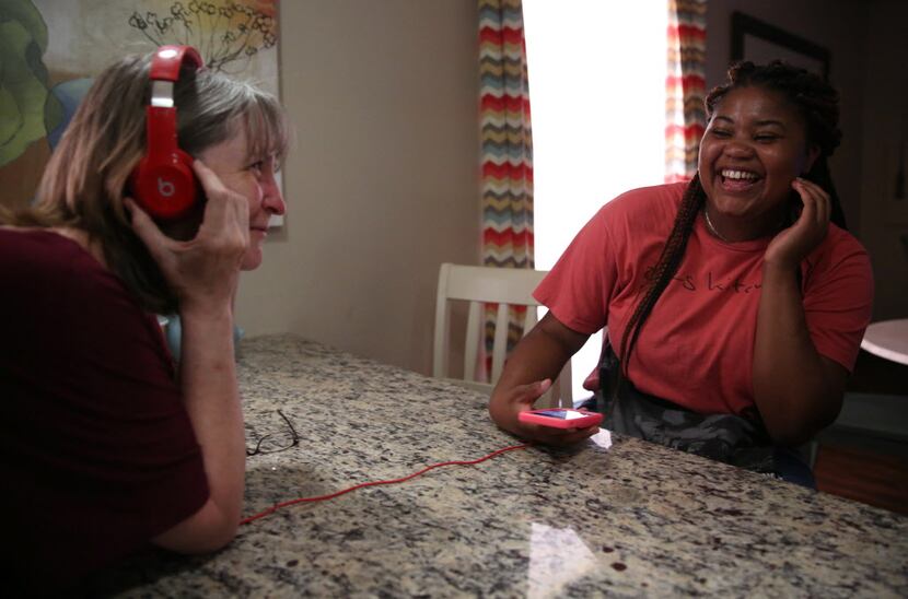 Resident Ebonie Jones (right) laughs at Ebby House Program Director Lisa Mumford's reaction...