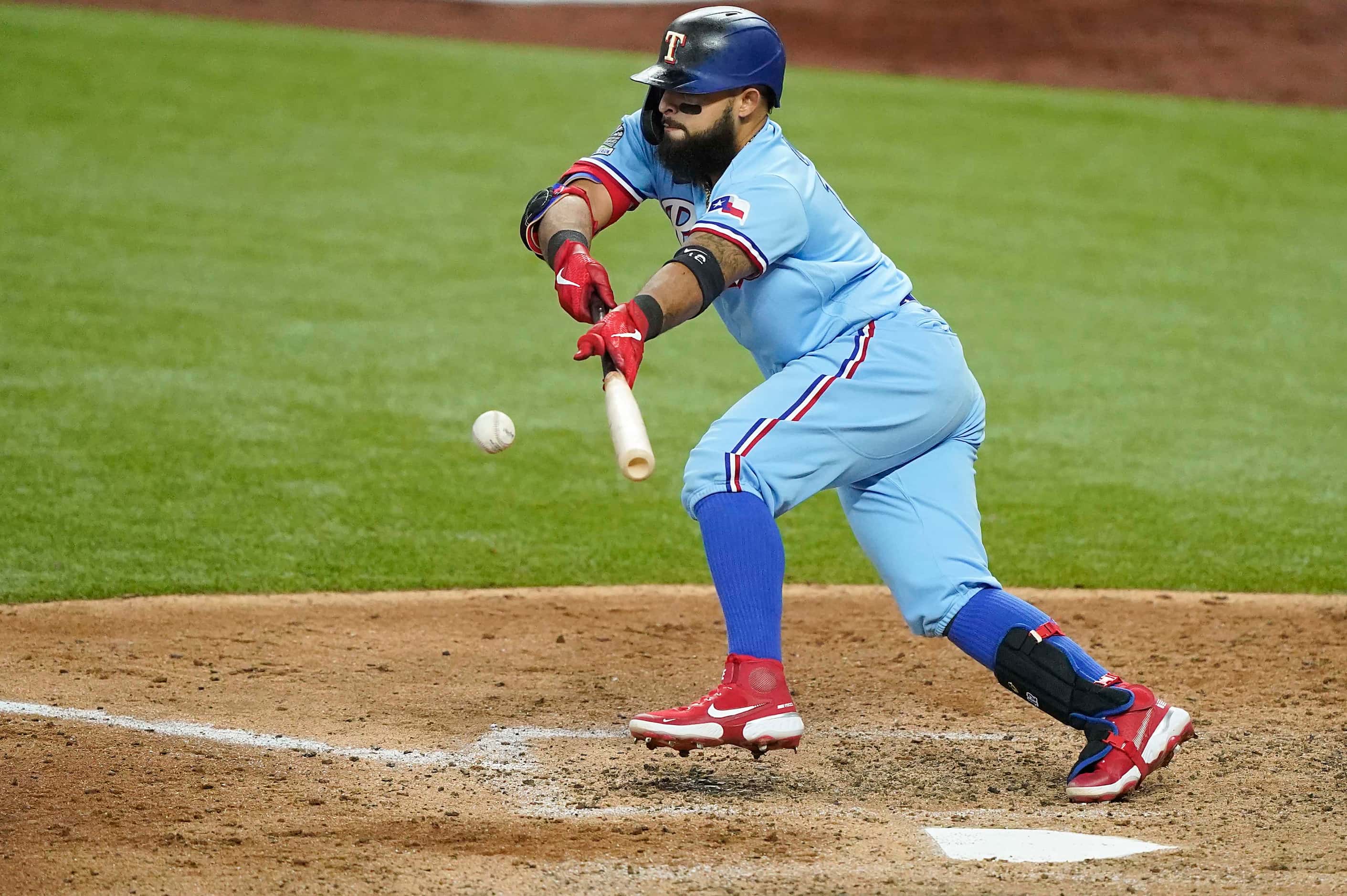 Texas Rangers second baseman Rougned Odor lays down a bunt during the sixth inning against...