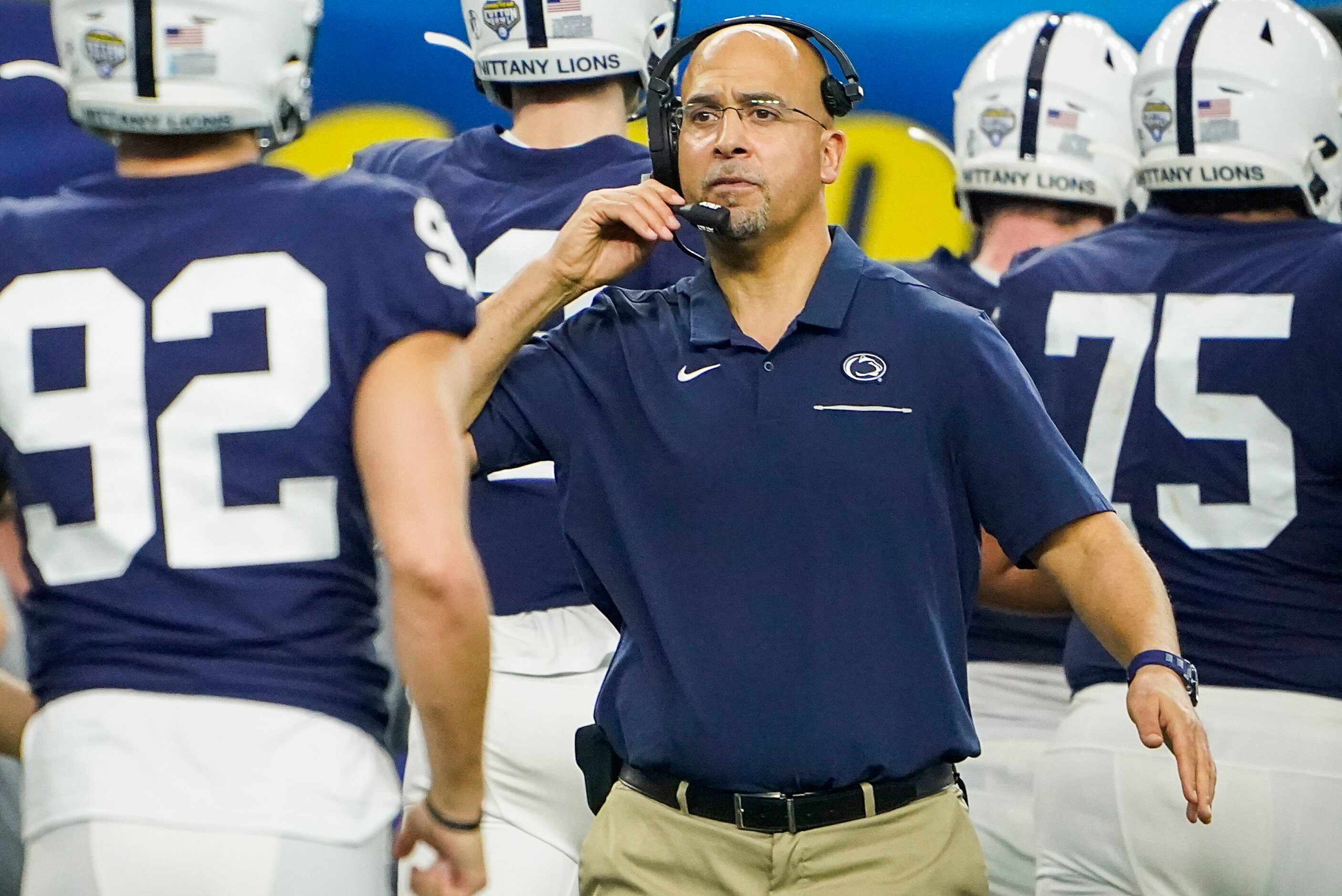 Penn State head coach James Franklin congratulates his players as they leave the field after...