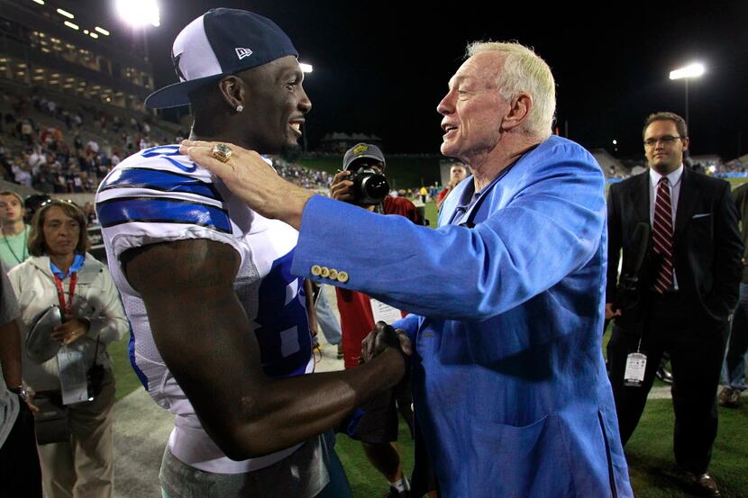 Dallas Cowboys owner Jerry Jones jokingly congratulates wide receiver Dez Bryant on a nice...