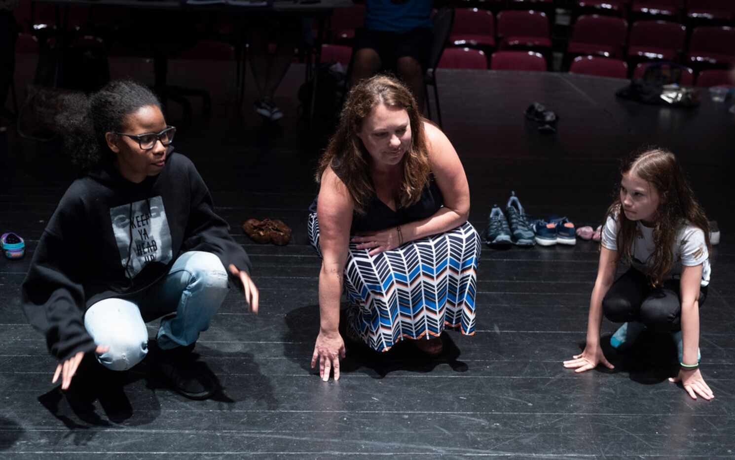 Director Mara Richards Bim (center) works with the teen actors of Cry Havoc in a rehearsal...