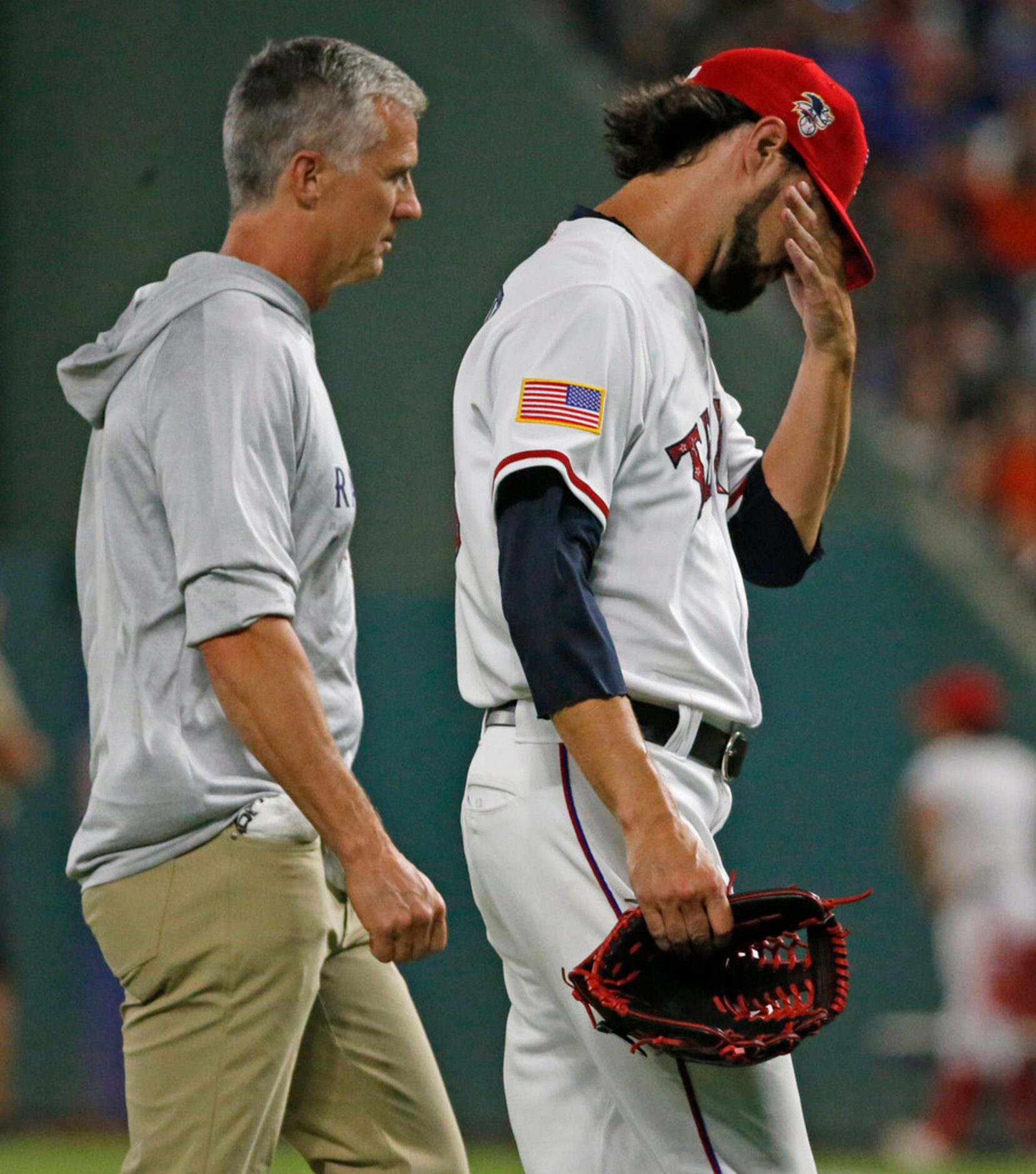 Texas Rangers relief pitcher Tony Barnette (43) has to leave the game with an apparent...