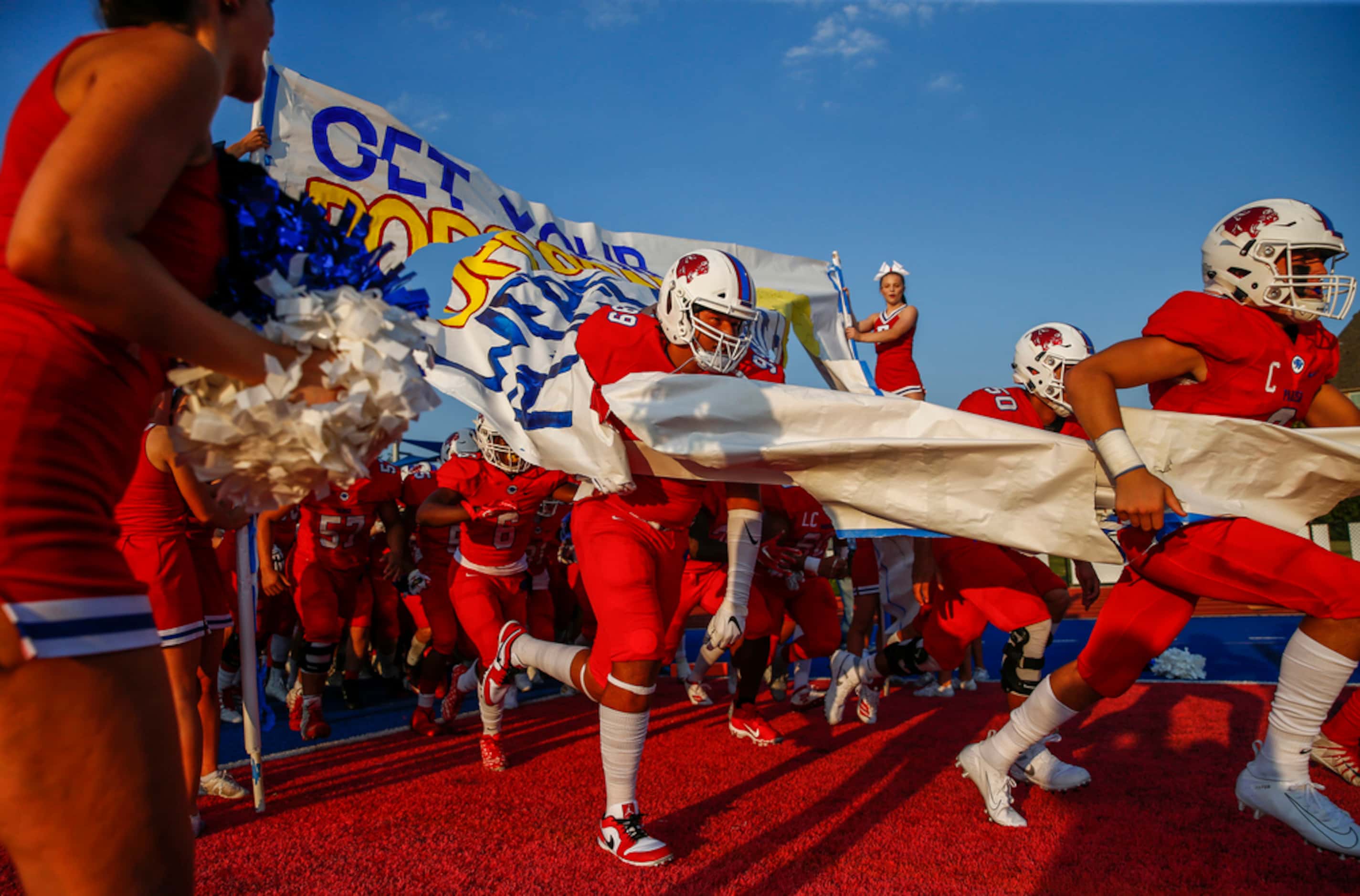The Parish Episcopal Panthers break onto the field prior to a high school football game...