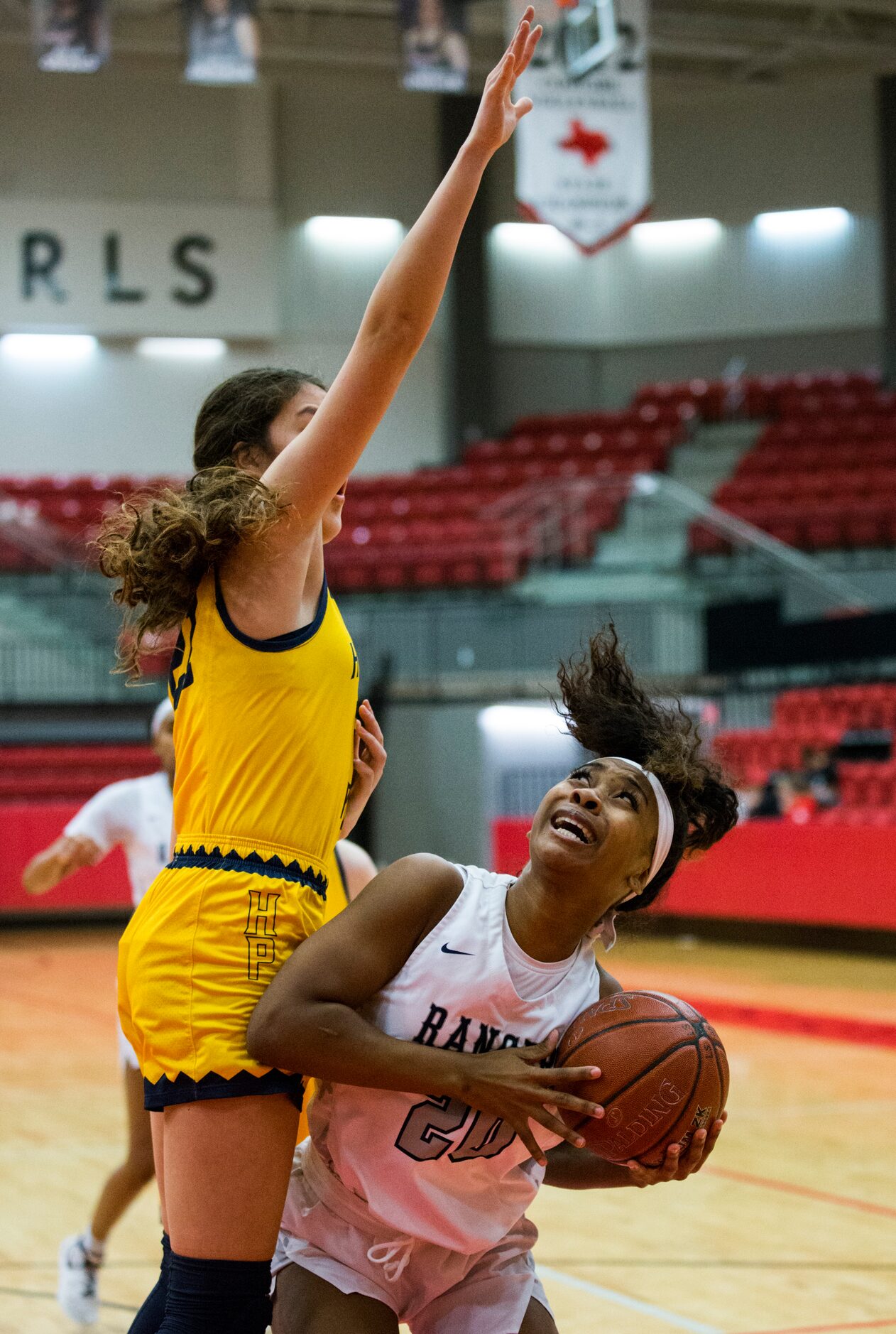 Frisco Lone Star forward Halley Carr (20) looks for a shot while defended by Highland Park...