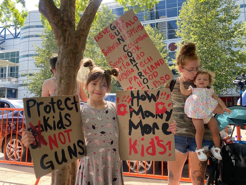 Annette and her mother Courtney Harris (with baby Dallas) protest across the street from the...