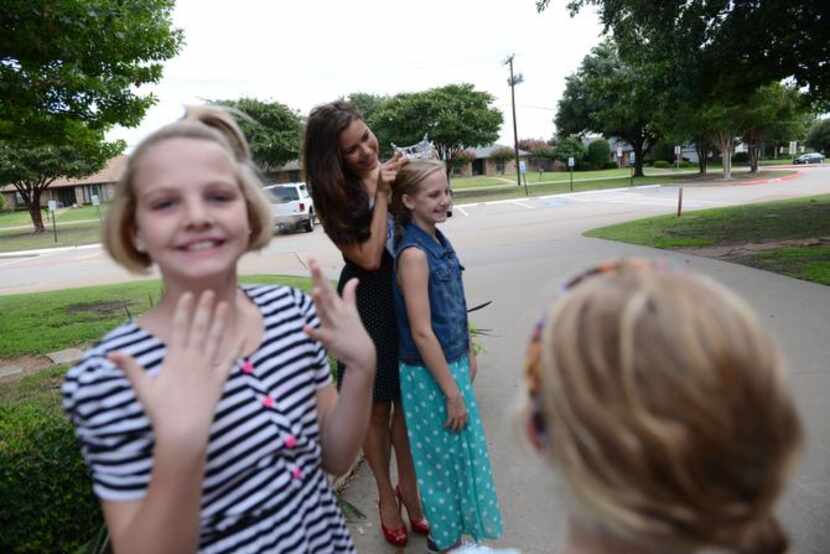 
Evans fits her crownon Claire Oden at Saigling Elementary School.
