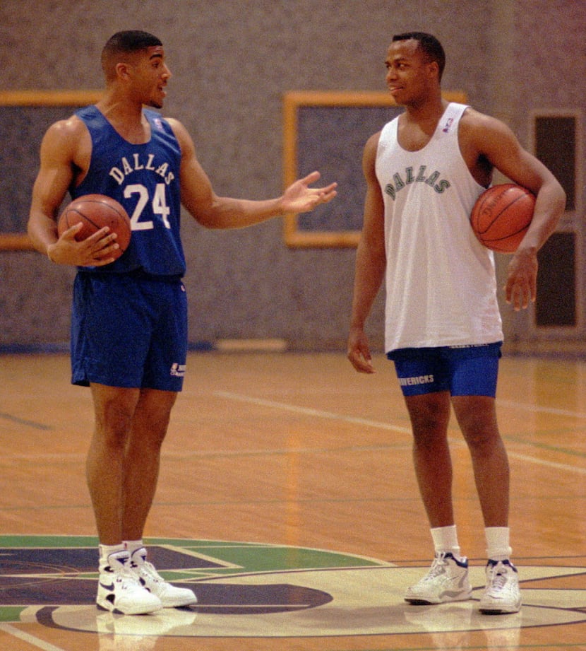 Mavericks rookie Jim Jackson talks with teammate Walter Bond after Jackson signed a contract...
