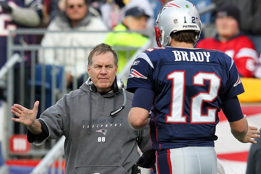 FOXBORO, MA - DECEMBER 4:   Tom Brady #12 of the New England Patriots celebrates with coach...