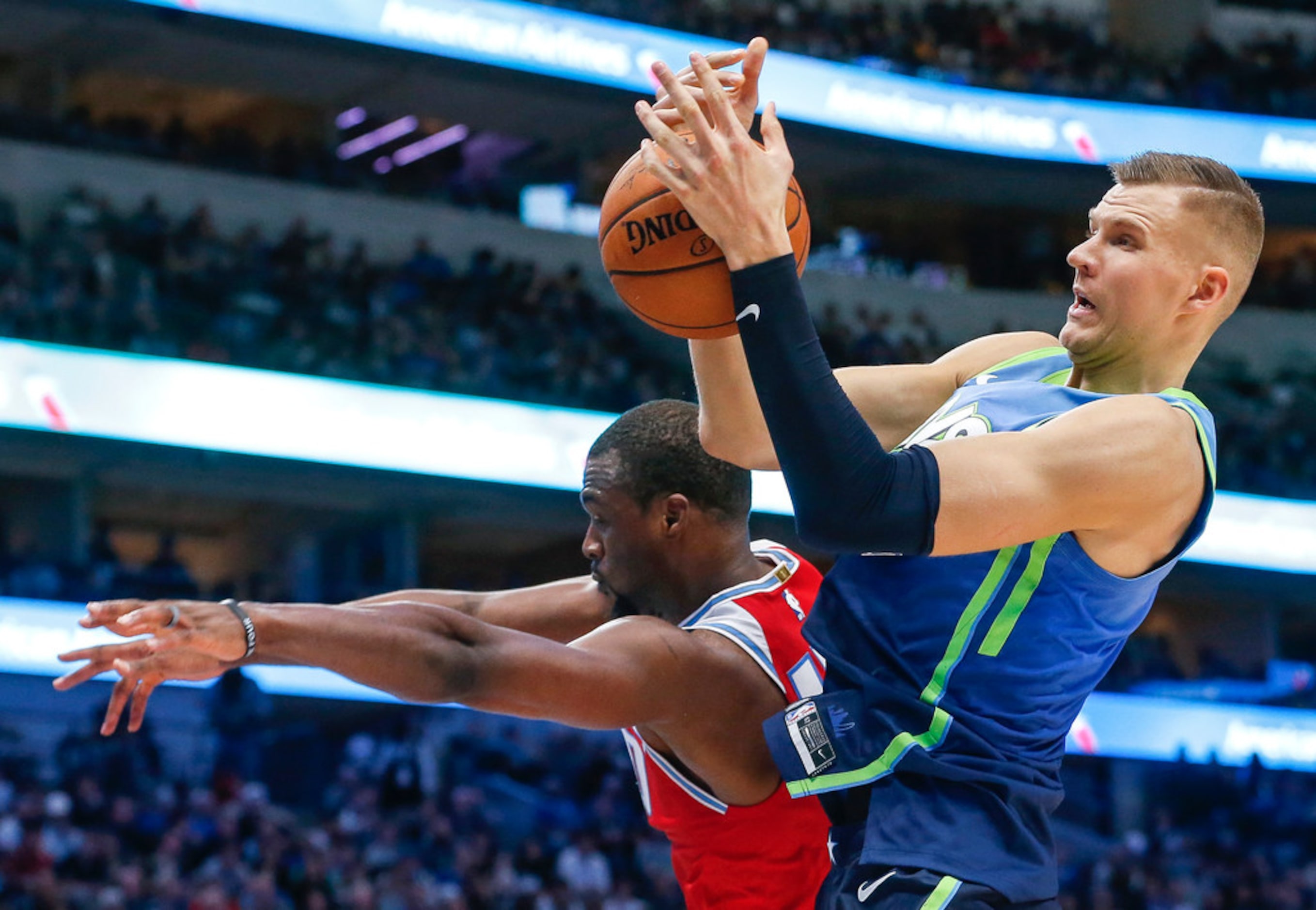 Dallas Mavericks forward Kristaps Porzingis (6) makes a rebound over Sacramento Kings...