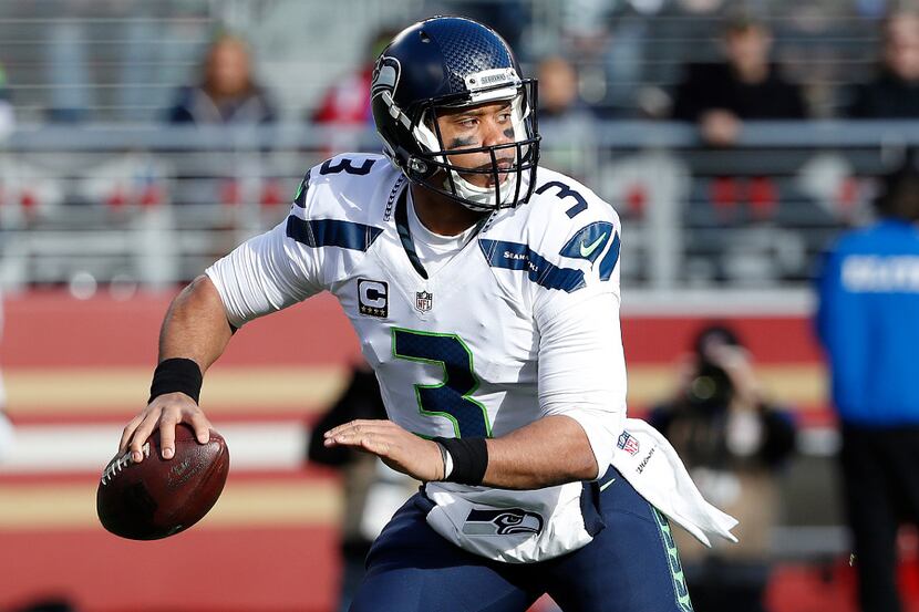 FILE - In this Jan. 1, 2017, file photo, Seattle Seahawks quarterback Russell Wilson (3)...