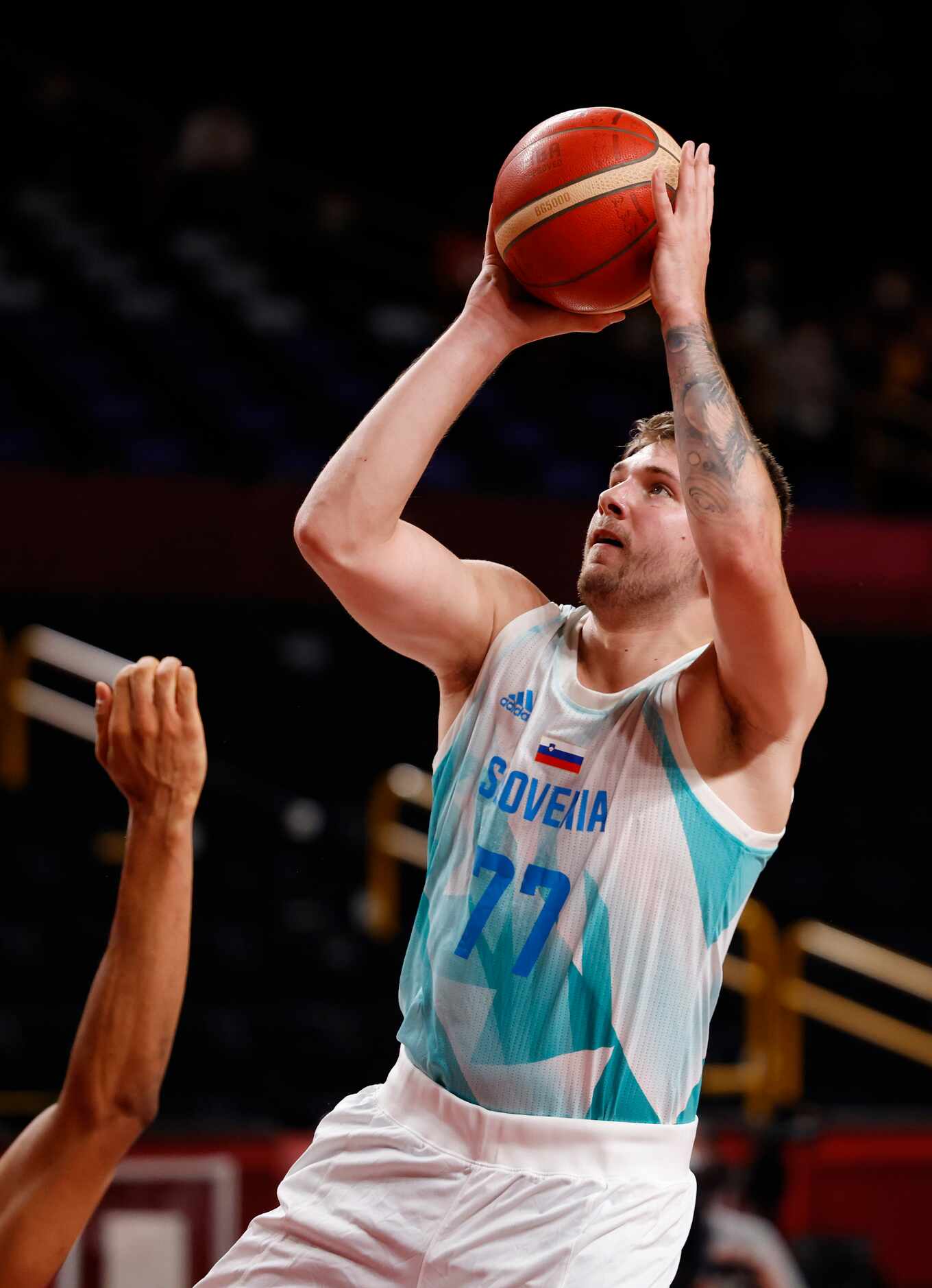Slovenia’s Luka Doncic (77) attempts a shot in a game against Germany during the first half...