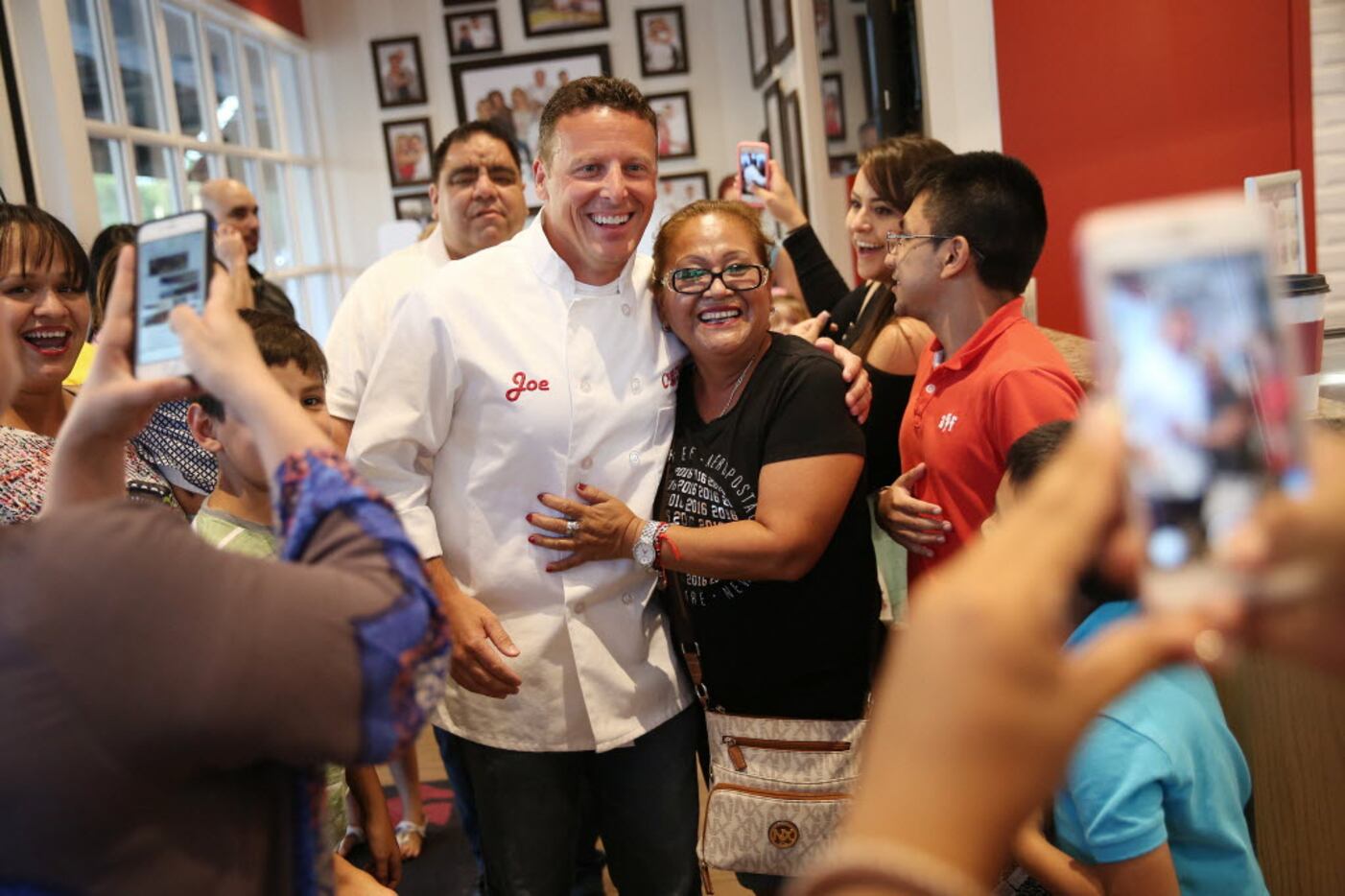 Joe Faugno, head baker, takes a photograph with Andrea Torres, of Monterrey, Mexico, during...