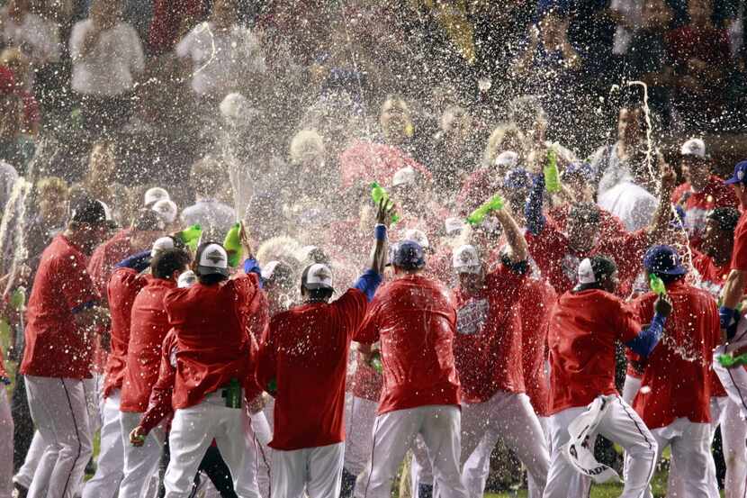Texas Ranger players celebrate their 6-1 victory against the New York Yankees in the sixth...