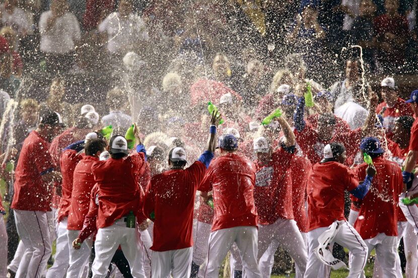 Texas Ranger players celebrate their 6-1 victory against the New York Yankees in the sixth...