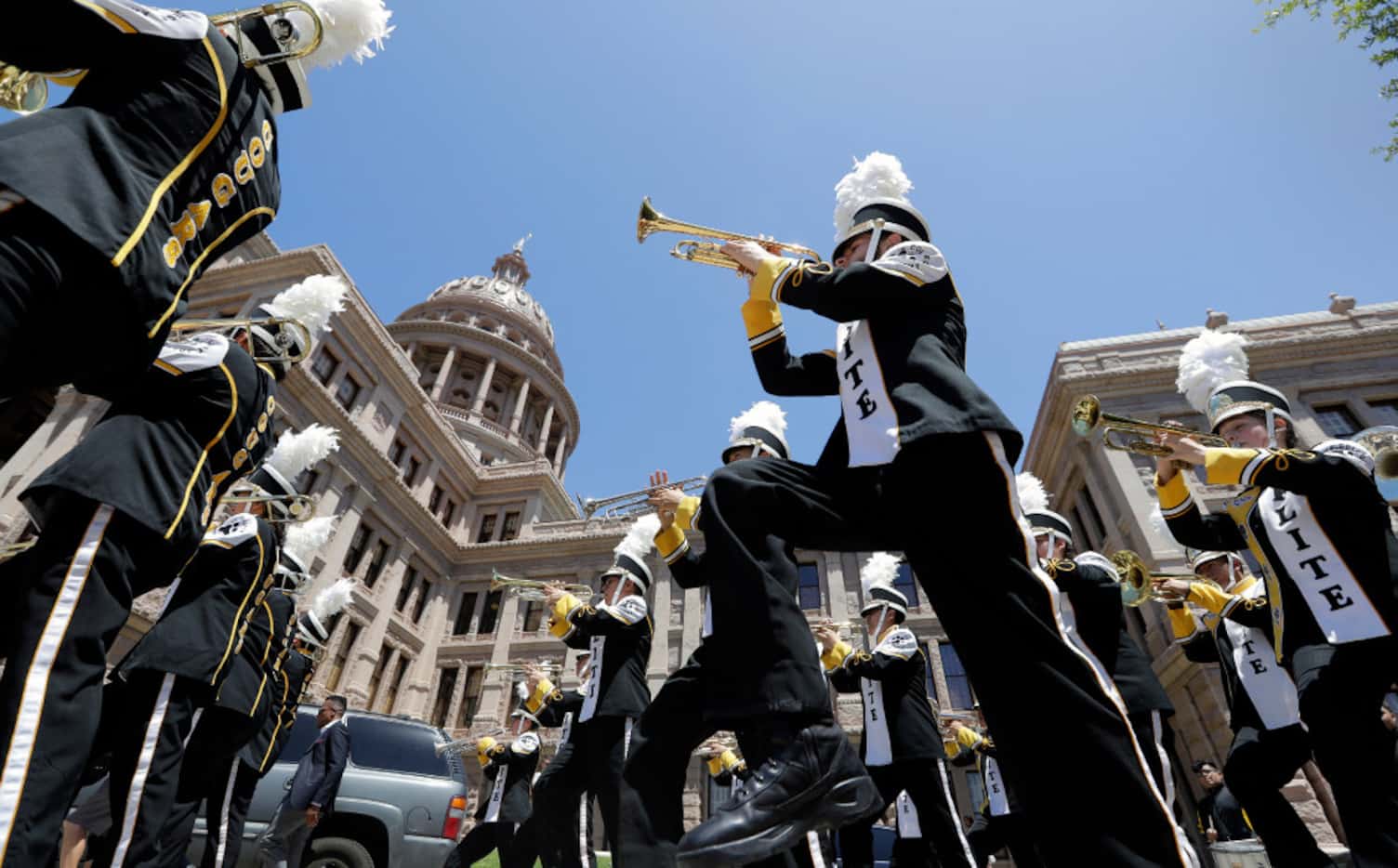 Members of the Elite College Prep Academy band from Houston march to the Texas Capitol for a...