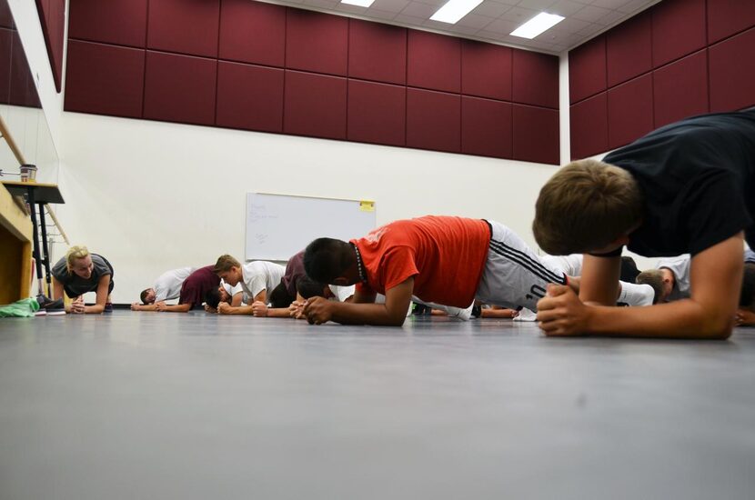 
Shannon Dunham (left) leads Farmer athletes through a series of stretches before teaching...