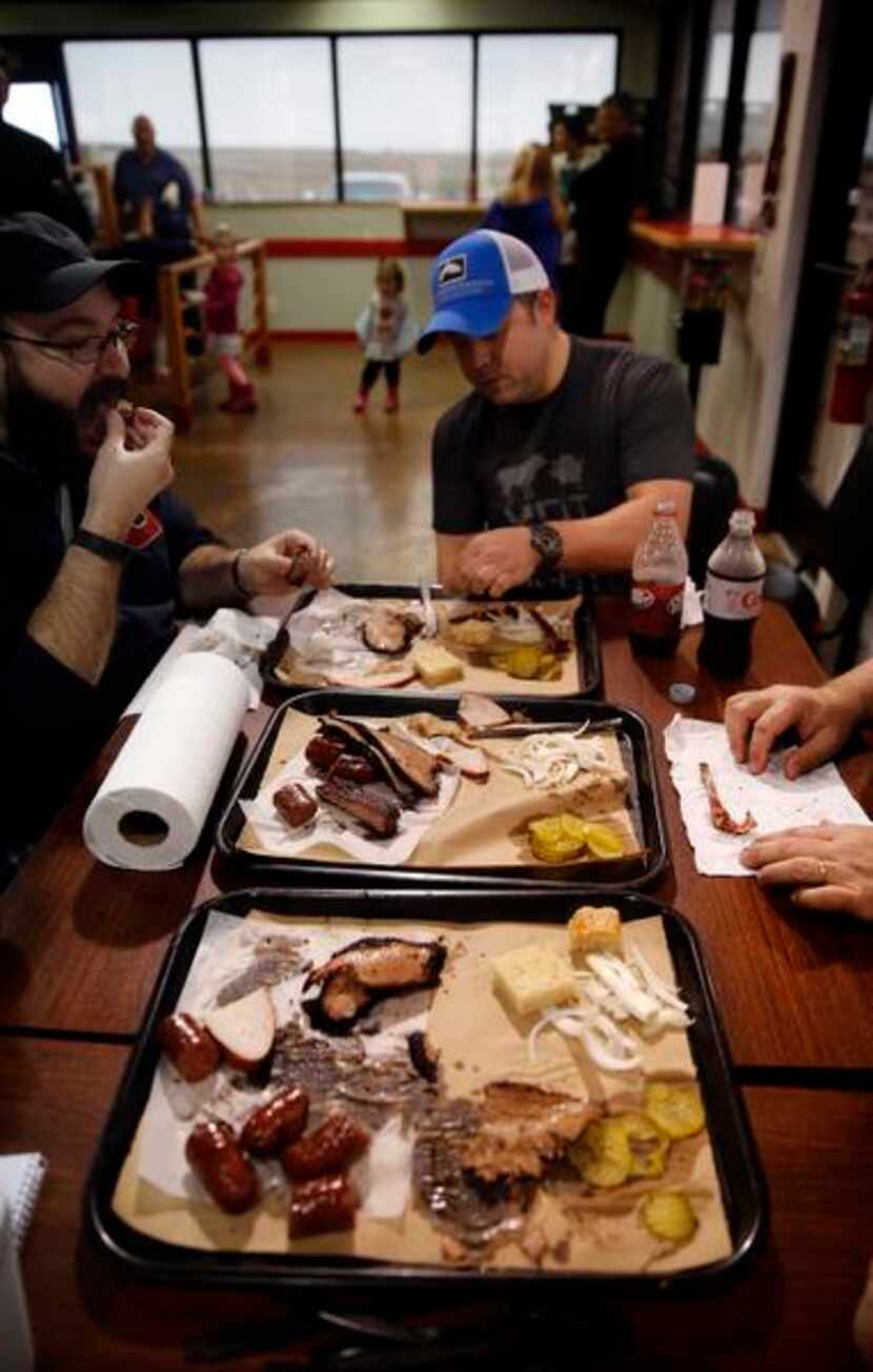 
The Texas BBQ Posse dives into trays full of smoked brisket, sausage, ribs and turkey at...