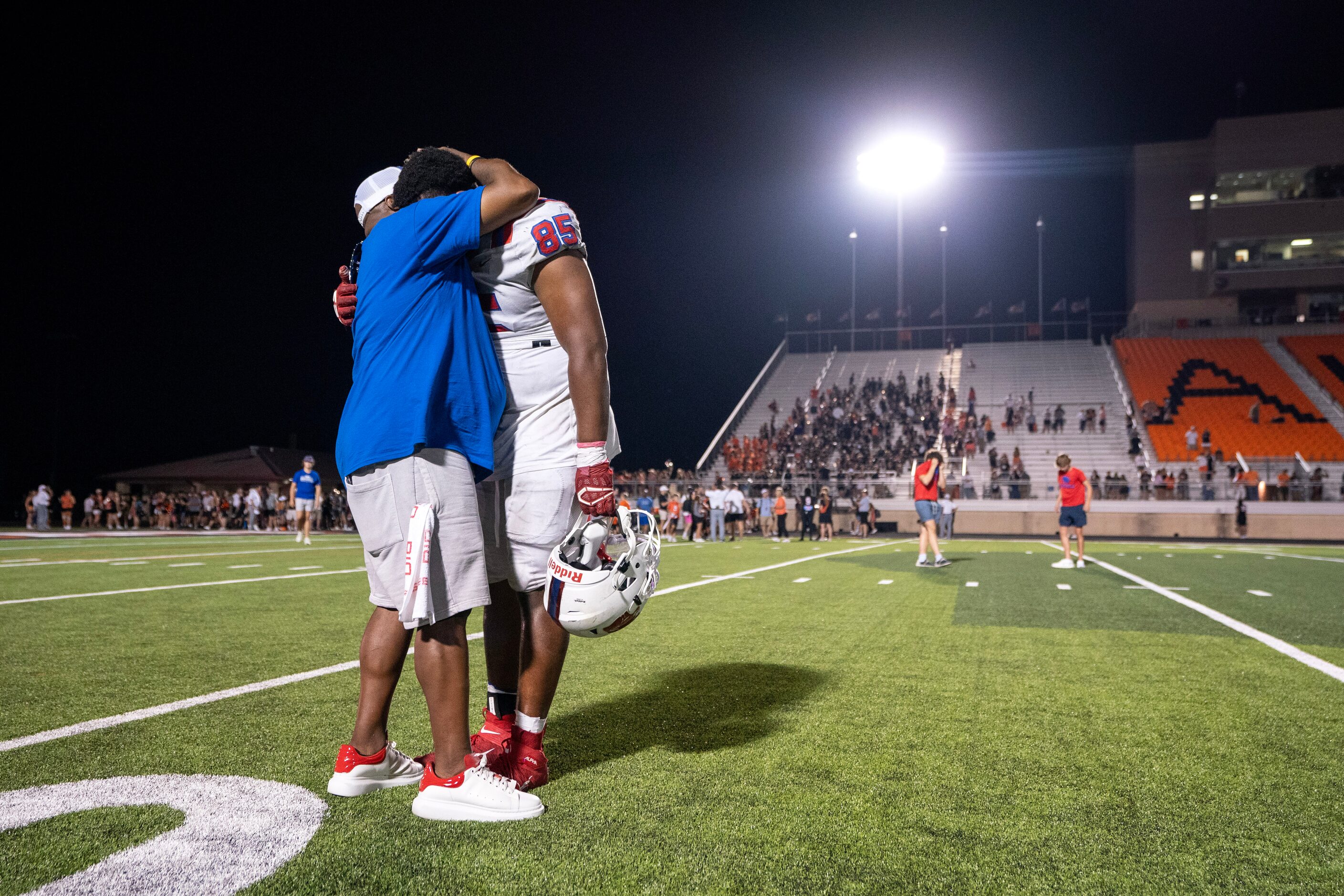 Parish Episcopal senior defensive lineman Caleb Mitchell Irving (85) is consoled by his...