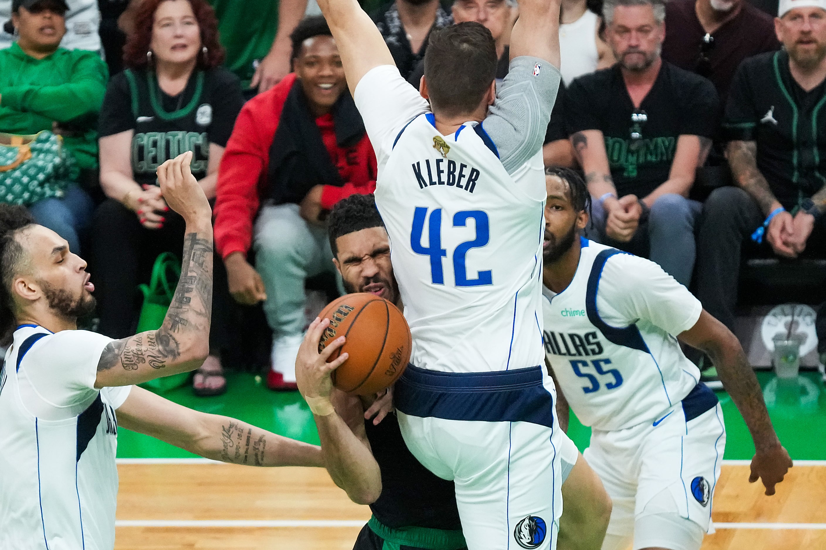 Boston Celtics forward Jayson Tatum (0) is fouled by Dallas Mavericks forward Maxi Kleber...