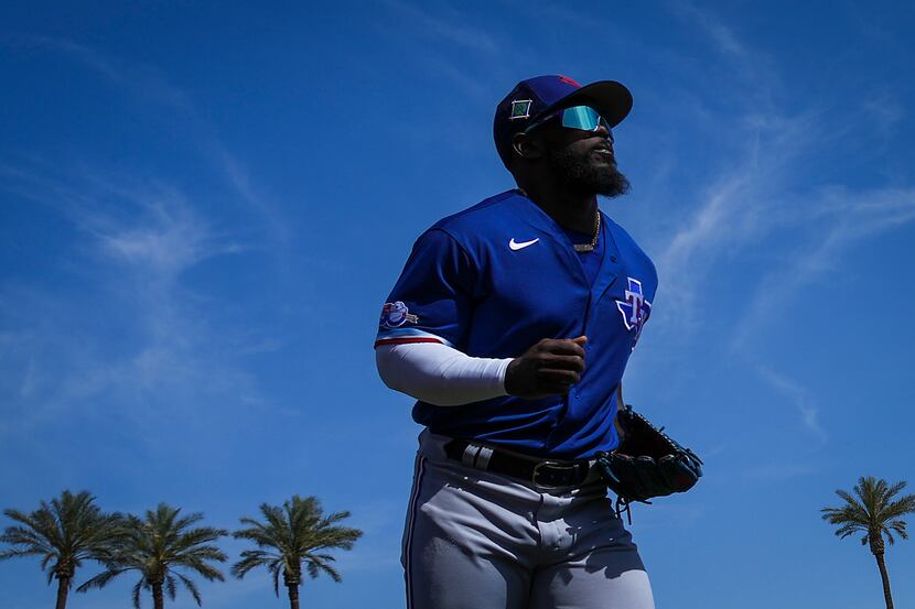 Texas Rangers outfielder Adolis García warms up before a spring training game against the...