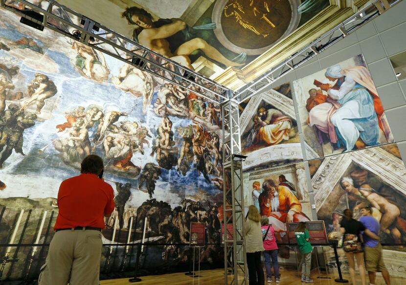 People look at the photo reproduction of the Sistine Chapel at Fair Park. (Nathan...