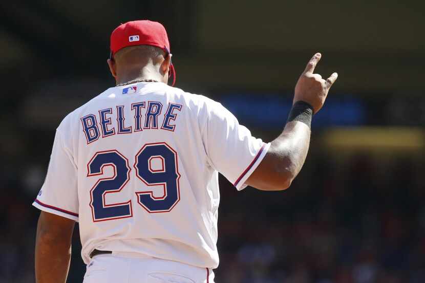 FILE — Texas Rangers third baseman Adrian Beltre (29) signals after the second out in the...