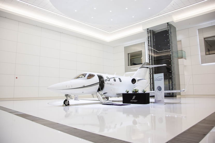 A Volato Hondajet parked in a showroom.