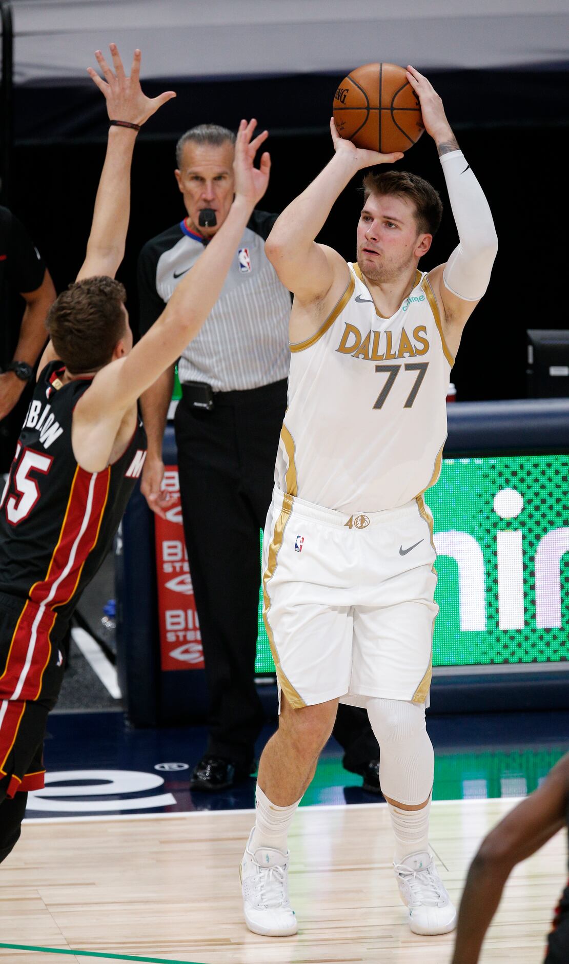 Dallas Mavericks guard Luka Doncic (77) attempts a shot as Miami Heat forward Duncan...
