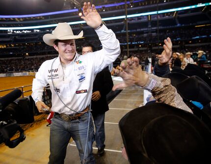 Tie-down roping champion Reese Riemer of Stinnett celebrates with other champions during the...