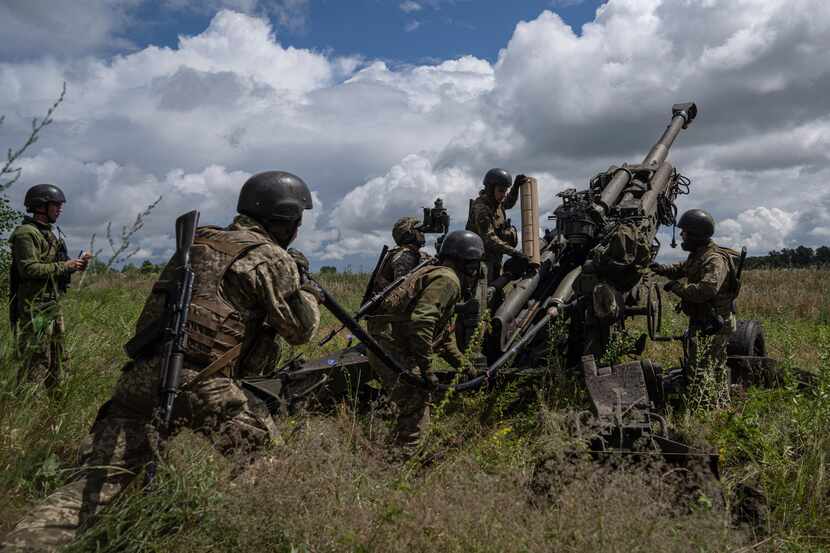 Ukrainian troops prepare to fire at Russian positions with a U.S.-supplied M777 howitzer in...