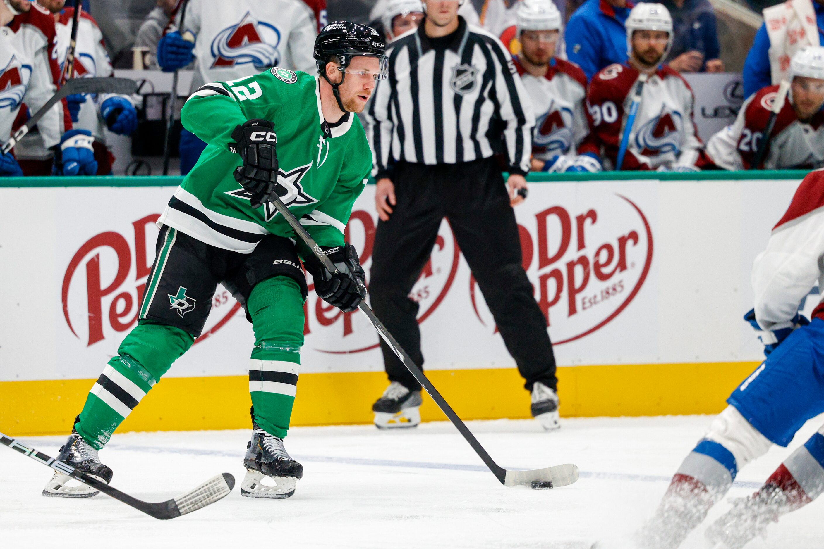 Dallas Stars center Radek Faksa (12) skates with the puck during the first period of an NHL...