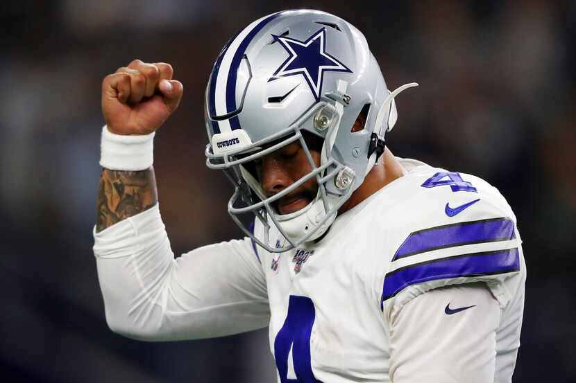 ARLINGTON, TEXAS - OCTOBER 20: Dak Prescott #4 of the Dallas Cowboys celebrates a first...