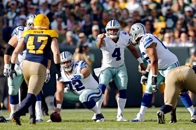Dallas Cowboys quarterback Dak Prescott (4) calls a play at the line during the first half...