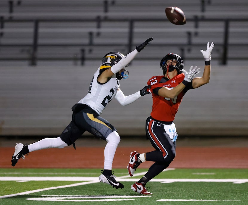 Despite the hold by Forney defensive back Chris Turner (24), Rockwall-Heath receiver...