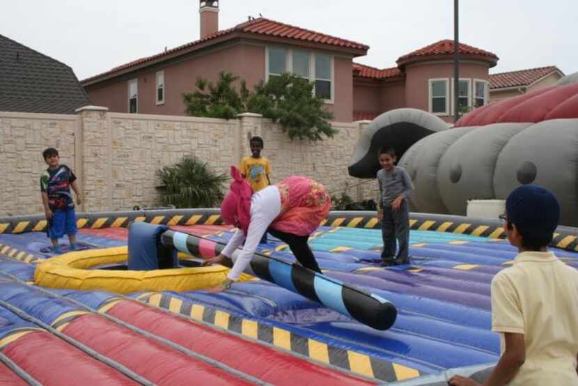 
Kids play on an inflatable playground during the Islamic Center of Irving’s cultural fair. 
