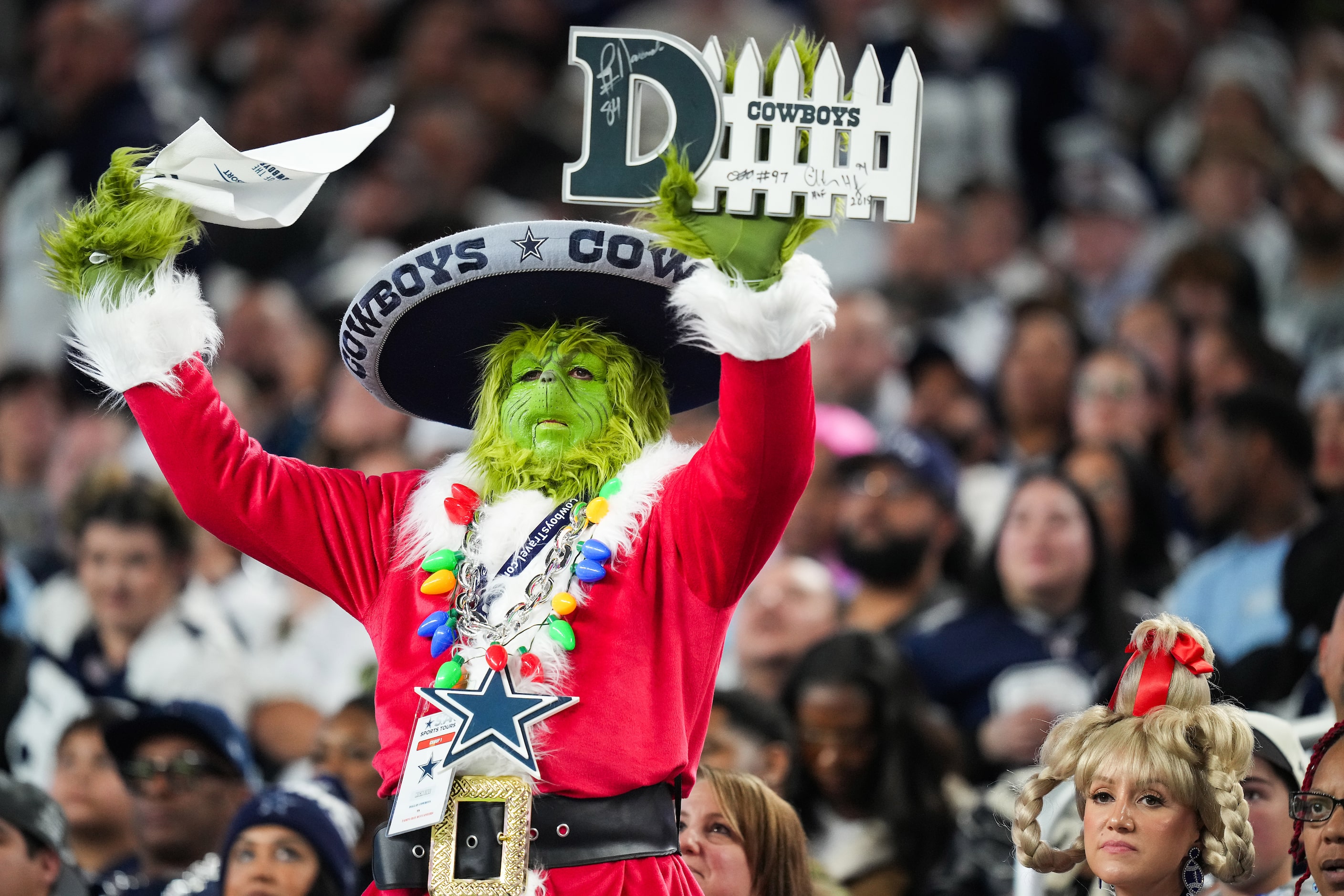 Dallas Cowboys fan Chris Raiser wears a Grinch costume as he cheers for the Cowboys defense...