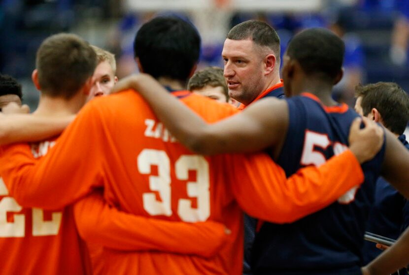 Wakeland head coach Tyron Lee talks to his tem during a time out in the first quarter as...