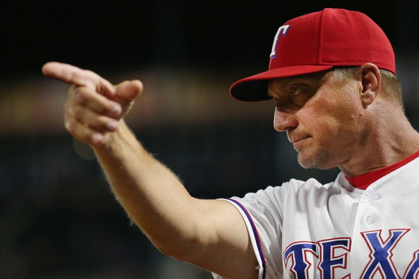 Texas Rangers manager Jeff Banister reacts after second baseman Rougned Odor scored a run on...
