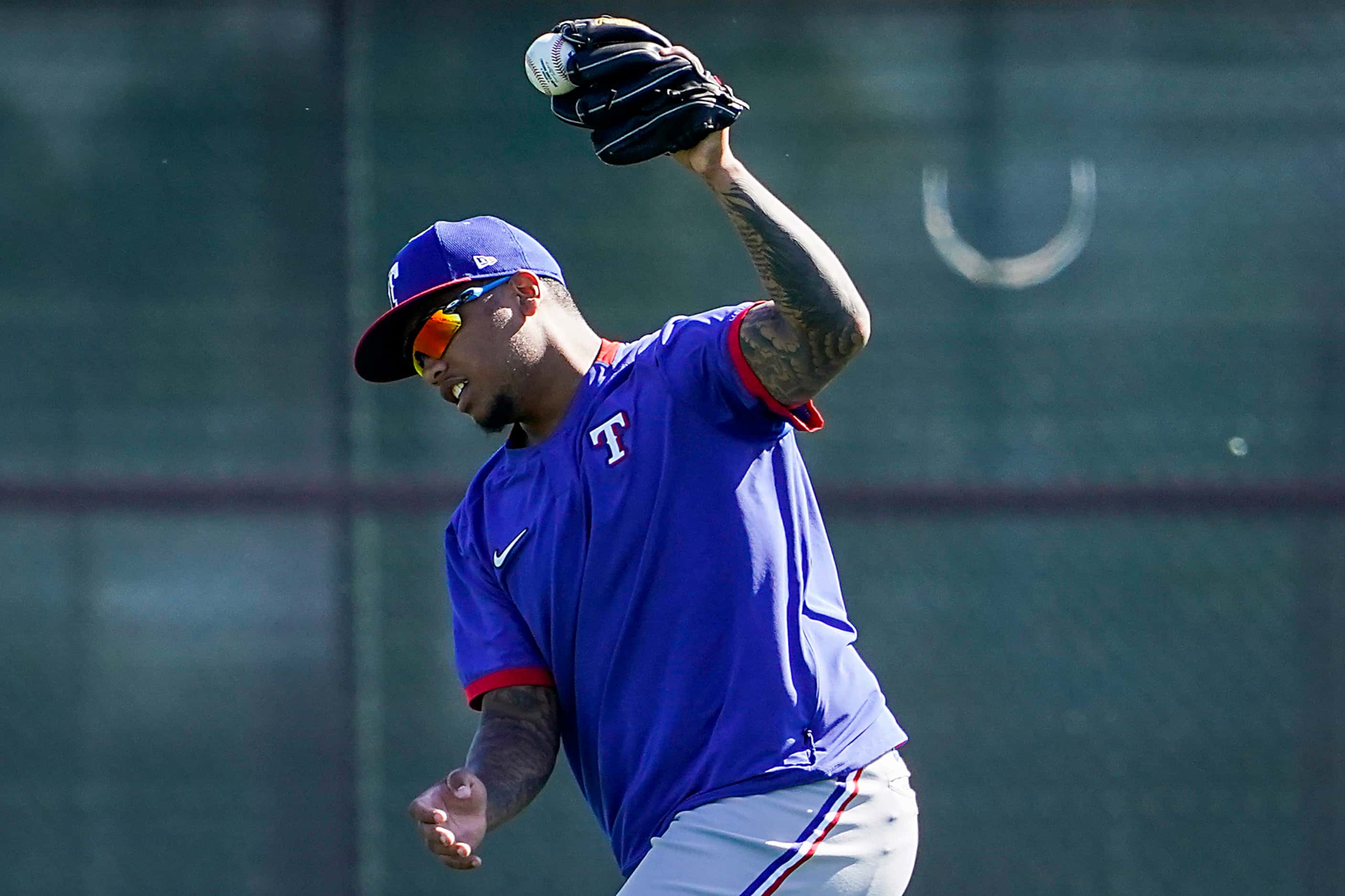 Texas Rangers outfielder Willie Calhoun makes a catch while participating in a fielding...