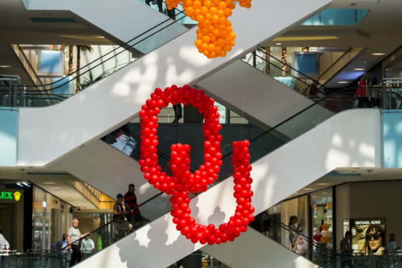 Balloon logos of The University of Texas and Oklahoma University are on display as their...