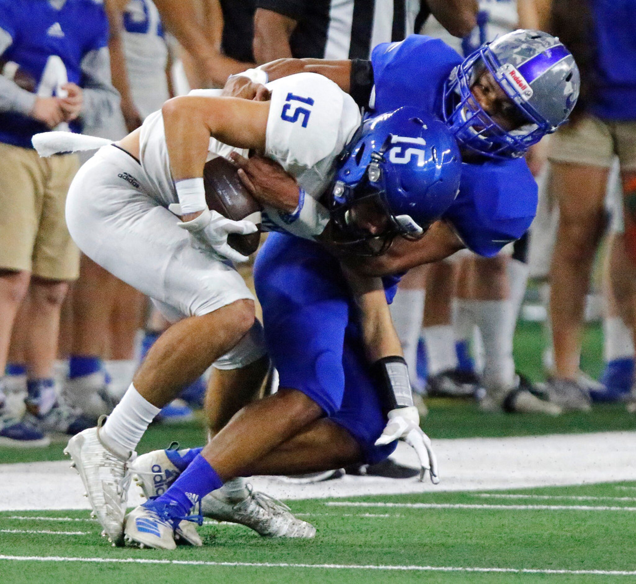 Gunter High School wide receiver David Denton (15) is brought down by Omaha Pewitt High...