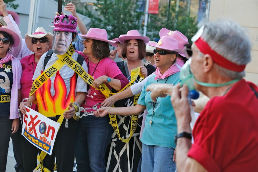 Members of Code Pink, including Danna Miller Pyke (right of fake Rex Tillerson), picket and...